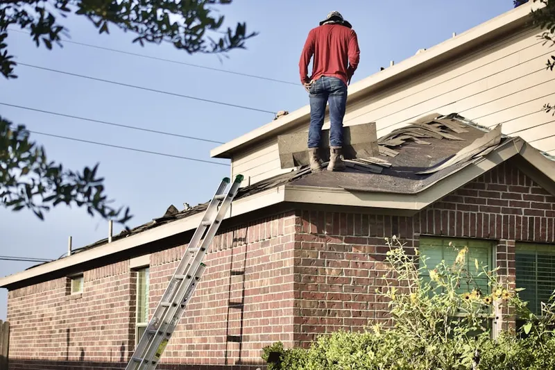 Professional roofer working on a residential roof in Yankee Hills